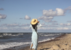 The girl at the shore with yellow hat